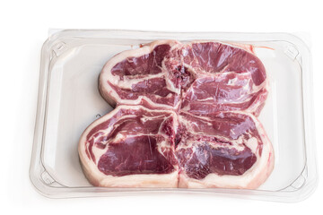 Raw lamb chops in vacuum package isolated on white