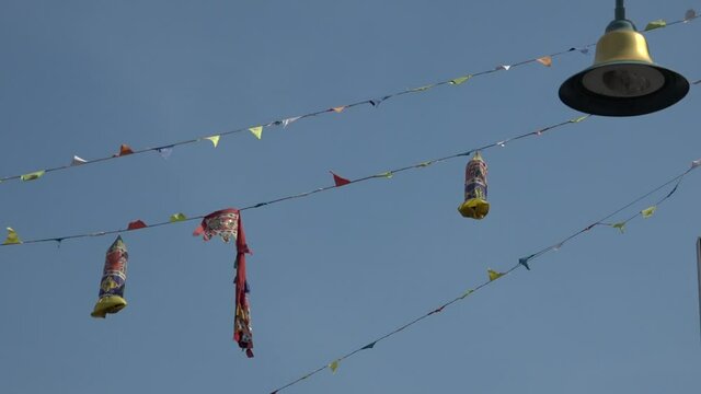Asian decoration on electrical cables hanging on top of Penang streets.