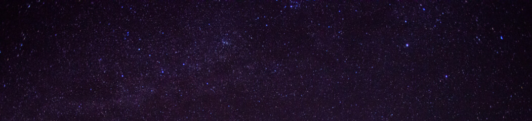 Panorama blue night sky milky way and star on dark background.Universe filled with stars, nebula and galaxy with noise and grain.Photo by long exposure and select white balance.Dark night sky.
