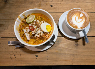 cup of coffee and bowl of boiled noodle