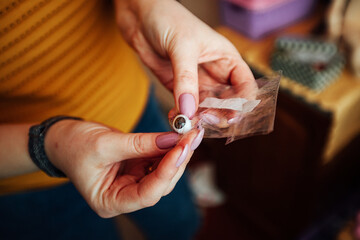 hold in your hand a toy shoe made for a doll