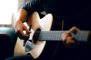 Young man playing acoustic guitar