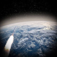 Fototapeta na wymiar Rocket in space, earth in distance. The elements of this image furnished by NASA.
