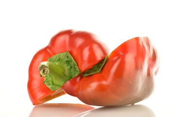 Two halves of red sweet pepper, close-up, isolated on white.