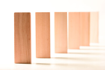 a row of wooden bars standing on the end face on a grey background.Career promotion concept