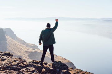 Obraz premium Unrecognizable man enjoying success of raising on mountain