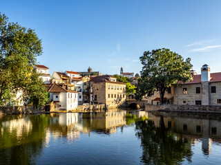 Old buildings in Viseu reflected on a Pavia river, Portugal - obrazy, fototapety, plakaty