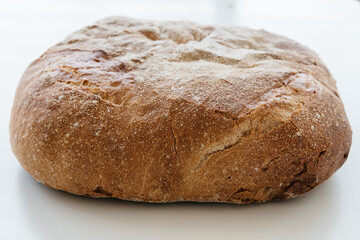 Freshly baked traditional bread on white table