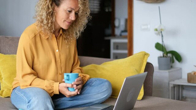 Young woman at home with laptop computer and connection - smart working free office home activity - modern people online job remote work lifestyle - female middle age at the desktop