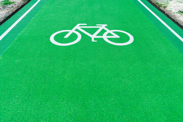 Symbol bicycle white in runway green. Path are for bicycle runway indicating a designated area for cycling.
