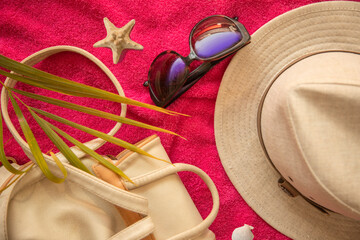 Travel, vacation and summer vacation concept. Beach accessories white straw hats seashells, sunglasses and a palm branch on  the sand