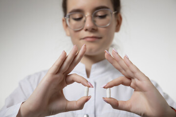 Female doctor hand hold pack of different tablet blisters at workplace. Panacea, life save service, prescribe medicament, legal drug store, disease healing, blood pressure concept. Letterbox view