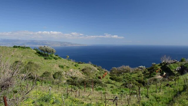 panoramic view of the Messina strait in a particular spring day with blue sky and limpid coast of Calabria with splashes of snow on the hills