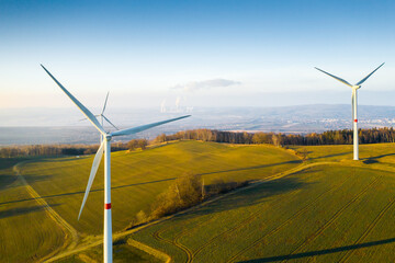 Panoramic view of wind turbines or wind mills in the field for electricity generation. 