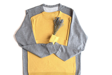 Concept for love and romance. Yellow and gray sweaters