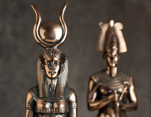 Egyptian goddess Isis with Tutankhamen on a brown background.
