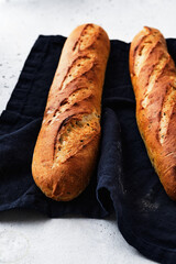 Close-up of a freshly baked baguette on a grey background. Food background