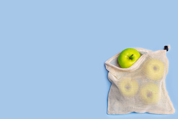 eco shopping bag with apples on a blue background