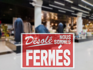SORRY WE ARE CLOSED lettering in French. Concept of closing stores due to the introduction of a lockdown to avoid coronavirus spreading