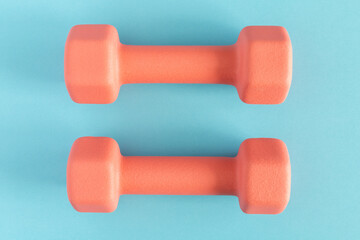 Dumbbells on blue background. Fitness, sport and workout concept flat lay