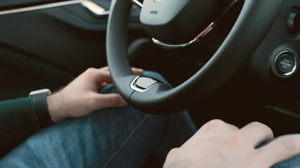 Man drives a car on auto pilot. Male hands on the knees while driving. 