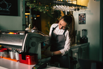 waitress preparing espresso coffee in cafeteria