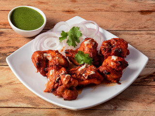 Murgh nizami kebab served on a rustic wooden background. Dishes and appetizers of indian cuisine,...