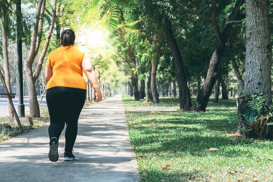 Blurred soft images, behind of Asian fat woman are exercise by running in the park in the morning,  to lose weight and good health, to people and health care concept.