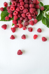 Ripe raspberries with green leaf isolated on white background.