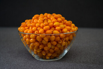 Sea buckthorn on a white background. Natural, organic sea buckthorn berries in a bowl