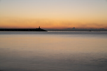 Beach and port of the town of Villajoyosa at sunrise, long exposure.