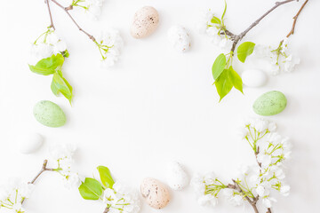 Flat lay easter composition with spring flowers and eggs on white background