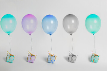 Five multi-colored balls with gifts on a white background. 
