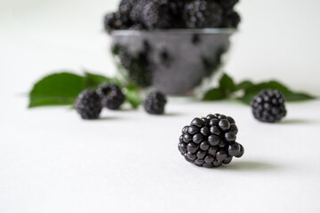 Fresh blackberry with green leaves isolated on white background. Ripe blackberry fruits with leaves.