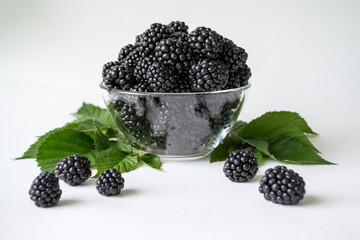 Fresh blackberry with green leaves isolated on white background. Ripe blackberry fruits with leaves.