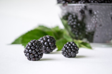 Fresh blackberry with green leaves isolated on white background. Ripe blackberry fruits with leaves.