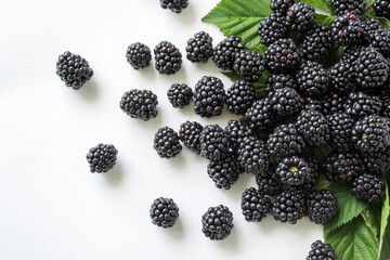 Fresh blackberry with green leaves isolated on white background. Ripe blackberry fruits with leaves.