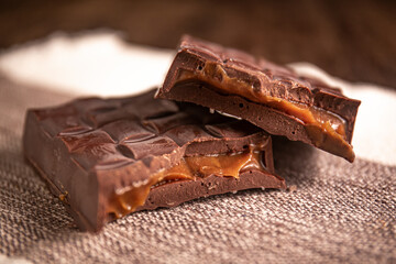 Broken assorted chocolate bar with caramel filling. Gluten free. Gourmet. Close up.