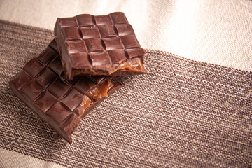 Broken assorted chocolate bar with caramel filling. Gluten free. Gourmet. Space for text.