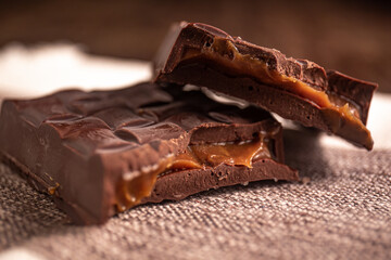 Broken assorted chocolate bar with caramel filling. Gluten free. Gourmet. Close up.