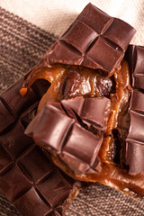 Broken assorted chocolate bar with caramel filling. Gluten free. Gourmet. Close up.