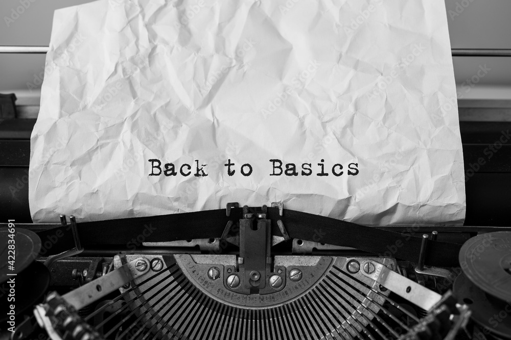 Fototapete text back to basics typed on retro typewriter