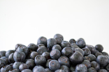 Fresh Blueberries in a bowl on white background. Juicy wild forest berries, bilberries. Healthy eating or nutrition.
