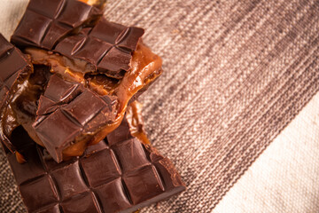 Broken assorted chocolate bar with caramel filling. Gluten free. Gourmet. Top view. Space for text.