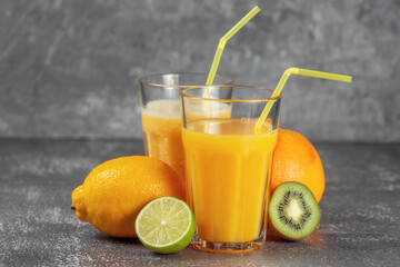Freshly squeezed orange juice and banana and orange smoothies in tall glasses