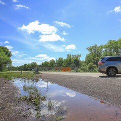 Closed road in Australia, rainy season. Road flooding, car turned back around. Metal fence, danger...