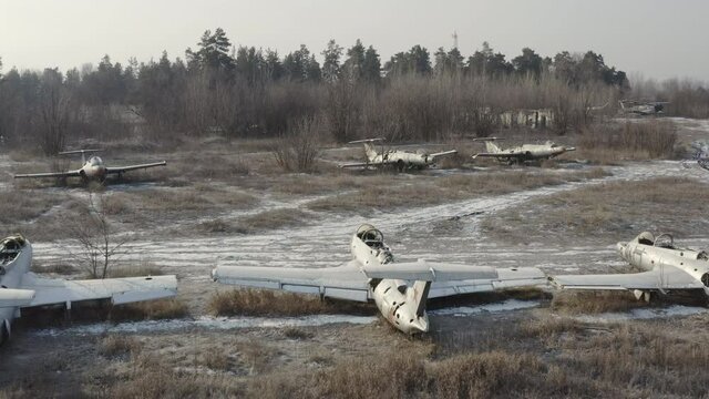 Several abandoned fighter planes at the military training ground - a cemetery of military equipment on an abandoned aerodrom. Forgotten strategic military base of the Soviet Union.