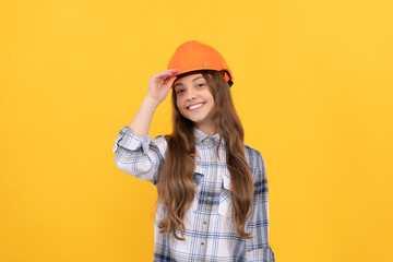 teen girl in helmet. builder kid in checkered shirt. building and construction concept.