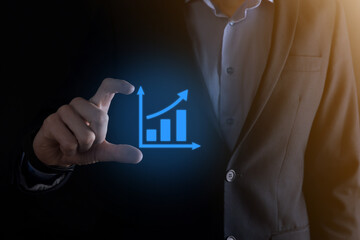 Businessman man holding a graph with positive profits growth. plan graph growth and increase of...