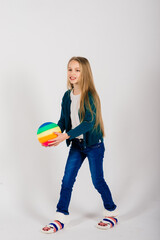 Beautiful girl holding coloured bright ball isolated on white